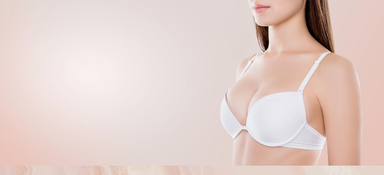Young woman after breast augmentation wearing white bra