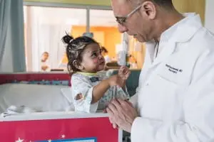 Dr. Stafford Broumand in this medical mission work with children