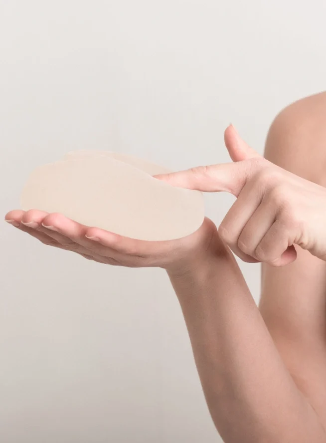hand touching the surface of a breast implant