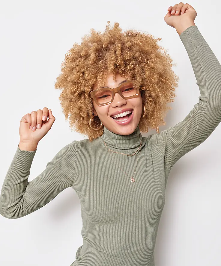 happy woman in long sleeve raising her arms sweat-free