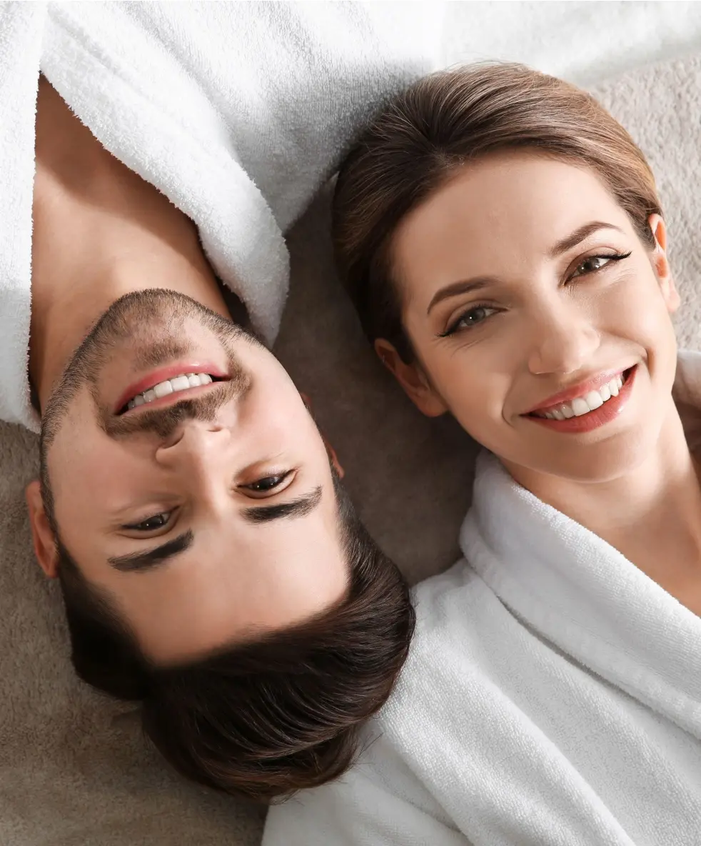 Happy young couple wearing bathrobes