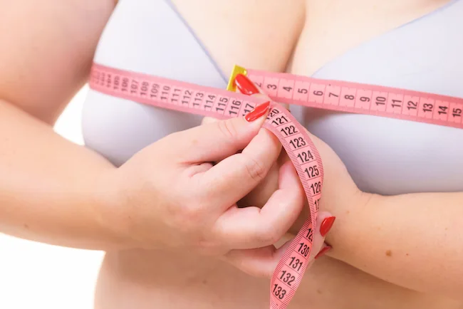 woman measuring her bust